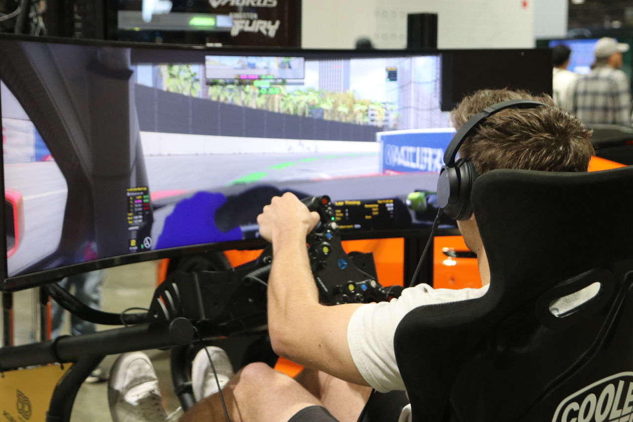 An attendee drives a simulation at the Formula 1 race